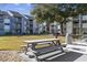 Exterior view featuring picnic table and grill perfect for outdoor dining and gatherings in a communal area at 7700 Porcher Dr. # 3207, Myrtle Beach, SC 29572