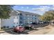 Well-maintained building exterior view with convenient parking, showcasing the building's neat appearance at 7700 Porcher Dr. # 3207, Myrtle Beach, SC 29572