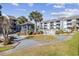 Attractive exterior featuring a well-maintained pool, gazebo, palm trees, and lush landscaping, enhancing its appeal at 7700 Porcher Dr. # 3207, Myrtle Beach, SC 29572
