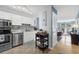 Bright kitchen featuring white cabinets, stainless steel appliances, and stylish backsplash at 7700 Porcher Dr. # 3207, Myrtle Beach, SC 29572