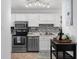 Well-lit kitchen featuring white cabinets, stainless steel appliances, and modern fixtures at 7700 Porcher Dr. # 3207, Myrtle Beach, SC 29572