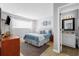 Serene main bedroom with a queen-sized bed, natural light, and an attached bathroom at 7700 Porcher Dr. # 3207, Myrtle Beach, SC 29572