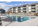 Community pool surrounded by lounge chairs, offering a relaxing outdoor space at 7700 Porcher Dr. # 3207, Myrtle Beach, SC 29572