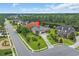 Aerial view of a suburban home with a backyard bordering a pond, surrounded by lush greenery at 8013 Wacobee Dr., Myrtle Beach, SC 29579