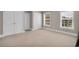 Bright bedroom with neutral walls, carpet flooring, and two windows with white blinds at 8013 Wacobee Dr., Myrtle Beach, SC 29579