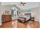 Bright bedroom with hardwood floors, vaulted ceiling, and large arched window at 8013 Wacobee Dr., Myrtle Beach, SC 29579