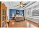 Spacious bedroom with tray ceilings, hardwood floors, and large windows offering natural light at 8013 Wacobee Dr., Myrtle Beach, SC 29579