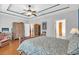 Spacious bedroom featuring tray ceilings, ceiling fan, and light hardwood floors at 8013 Wacobee Dr., Myrtle Beach, SC 29579