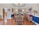 Elegant dining room featuring a large wooden table, hardwood floors, and decorative lighting at 8013 Wacobee Dr., Myrtle Beach, SC 29579