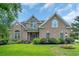 Charming brick home featuring a well-manicured lawn, mature landscaping, and beautiful curb appeal at 8013 Wacobee Dr., Myrtle Beach, SC 29579