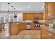 Well-equipped kitchen with stainless steel appliances, granite countertops, wooden cabinets, and tile flooring at 8013 Wacobee Dr., Myrtle Beach, SC 29579