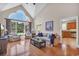 Bright living room featuring hardwood floors, vaulted ceiling and expansive windows at 8013 Wacobee Dr., Myrtle Beach, SC 29579