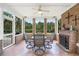 Covered patio with brick fireplace and tiled floor, offering a cozy outdoor seating area at 8013 Wacobee Dr., Myrtle Beach, SC 29579