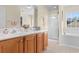 Bathroom featuring double sink vanity, large mirror, glass enclosed shower, and soaking tub at 864 Barn Owl Ct. # 864, Myrtle Beach, SC 29579