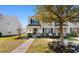 Charming two-story home with an American flag, mature landscaping, and a sidewalk at 864 Barn Owl Ct. # 864, Myrtle Beach, SC 29579
