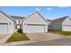 Exterior shot of garages with white doors and neutral siding at 864 Barn Owl Ct. # 864, Myrtle Beach, SC 29579