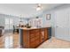 Kitchen island with sink, wood cabinets, and an open layout to the living room and dining area at 864 Barn Owl Ct. # 864, Myrtle Beach, SC 29579