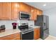 Kitchen featuring stainless steel appliances, wood cabinets and subway tile backsplash at 864 Barn Owl Ct. # 864, Myrtle Beach, SC 29579