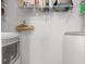 Functional laundry room with modern washer and dryer, storage shelves, and ample space for organizing essentials at 864 Barn Owl Ct. # 864, Myrtle Beach, SC 29579