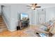 Stylish living room with a staircase, hardwood floors, modern TV, and comfortable seating arrangement at 864 Barn Owl Ct. # 864, Myrtle Beach, SC 29579