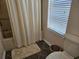 Bathroom area showcasing a shower with curtain and a toilet near the window at 927 Edge Dr., North Myrtle Beach, SC 29582