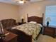 Bedroom with a bed with floral bedding, dressers, and ceiling fan at 927 Edge Dr., North Myrtle Beach, SC 29582