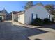 View of home's exterior featuring clean white siding, brick trim, and an outdoor AC unit on concrete pad at 927 Edge Dr., North Myrtle Beach, SC 29582