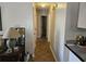 Hallway with beige walls, tile flooring, and a view into a bathroom at 927 Edge Dr., North Myrtle Beach, SC 29582