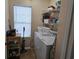 Functional laundry area with washer, dryer, shelving, and natural light at 927 Edge Dr., North Myrtle Beach, SC 29582