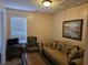 Inviting living area with window, TV, comfortable seating arrangement including a couch and armchair at 927 Edge Dr., North Myrtle Beach, SC 29582