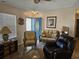 Cozy living room featuring wicker furniture, a blue door, and nautical decor at 927 Edge Dr., North Myrtle Beach, SC 29582