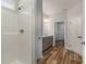 Bright bathroom featuring walk-in shower, gray vanity, and wood flooring at 1004 Woodside Dr., Conway, SC 29526