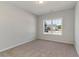 Bright bedroom with neutral tones, carpet, and a large window offering neighborhood views at 1004 Woodside Dr., Conway, SC 29526