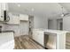 Modern kitchen with white cabinets, stainless steel appliances, and wood-look flooring at 1004 Woodside Dr., Conway, SC 29526