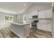 Eat-in kitchen featuring stainless appliances, an island with seating, and bright natural light at 1004 Woodside Dr., Conway, SC 29526