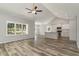 Bright living room with large windows, flowing into a kitchen with island and stainless steel appliances at 1004 Woodside Dr., Conway, SC 29526