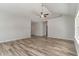 Spacious living room featuring wood-look flooring, vaulted ceiling, and a ceiling fan at 1004 Woodside Dr., Conway, SC 29526