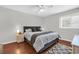A bright bedroom with a large bed, a ceiling fan and dark wood flooring at 10301 North Kings Hwy. # 21-4, Myrtle Beach, SC 29572