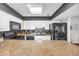 Bright kitchen featuring granite countertops, black appliances, and white cabinets, offering a modern and stylish cooking space at 10301 North Kings Hwy. # 21-4, Myrtle Beach, SC 29572
