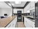 Well-lit kitchen with granite countertops, white cabinets, and modern black appliances, perfect for culinary enthusiasts at 10301 North Kings Hwy. # 21-4, Myrtle Beach, SC 29572