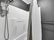 A well-lit shower space with a white shower curtain, overhead shower head and caddy at 10301 North Kings Hwy. # 21-4, Myrtle Beach, SC 29572