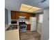 Functional kitchen featuring wood cabinets, updated appliances, and modern flooring at 1101 2Nd Ave. N # 403, Surfside Beach, SC 29575