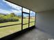 Screened porch overlooking a grassy area with manicured shrubbery at 1101 2Nd Ave. N # 403, Surfside Beach, SC 29575