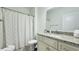 Bathroom features granite vanity with cream-colored cabinets and a shower-tub combo with a curtain at 130 Puffin Dr. # 2B, Pawleys Island, SC 29585