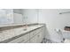 Well-lit bathroom vanity featuring granite countertops and ample storage space at 130 Puffin Dr. # 2B, Pawleys Island, SC 29585