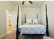 Tastefully styled bedroom with a four-poster bed, carpet, white walls, and a ceiling fan at 130 Puffin Dr. # 2B, Pawleys Island, SC 29585