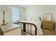 Cozy bedroom with neutral carpet, white walls, dresser, and natural light from the window at 130 Puffin Dr. # 2B, Pawleys Island, SC 29585