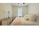 Calming bedroom with white walls, carpet, a window, and a side table with a lamp at 130 Puffin Dr. # 2B, Pawleys Island, SC 29585