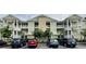 Inviting condo building with neutral paint, white trim, ample parking, and balconies on each floor at 130 Puffin Dr. # 2B, Pawleys Island, SC 29585