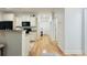 Kitchen boasts cream-colored cabinets and granite countertops connecting to hallway at 130 Puffin Dr. # 2B, Pawleys Island, SC 29585